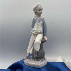 Lladro “Boy with Yacht/Sailor Boy with Toy Yacht" a retired porcelain piece